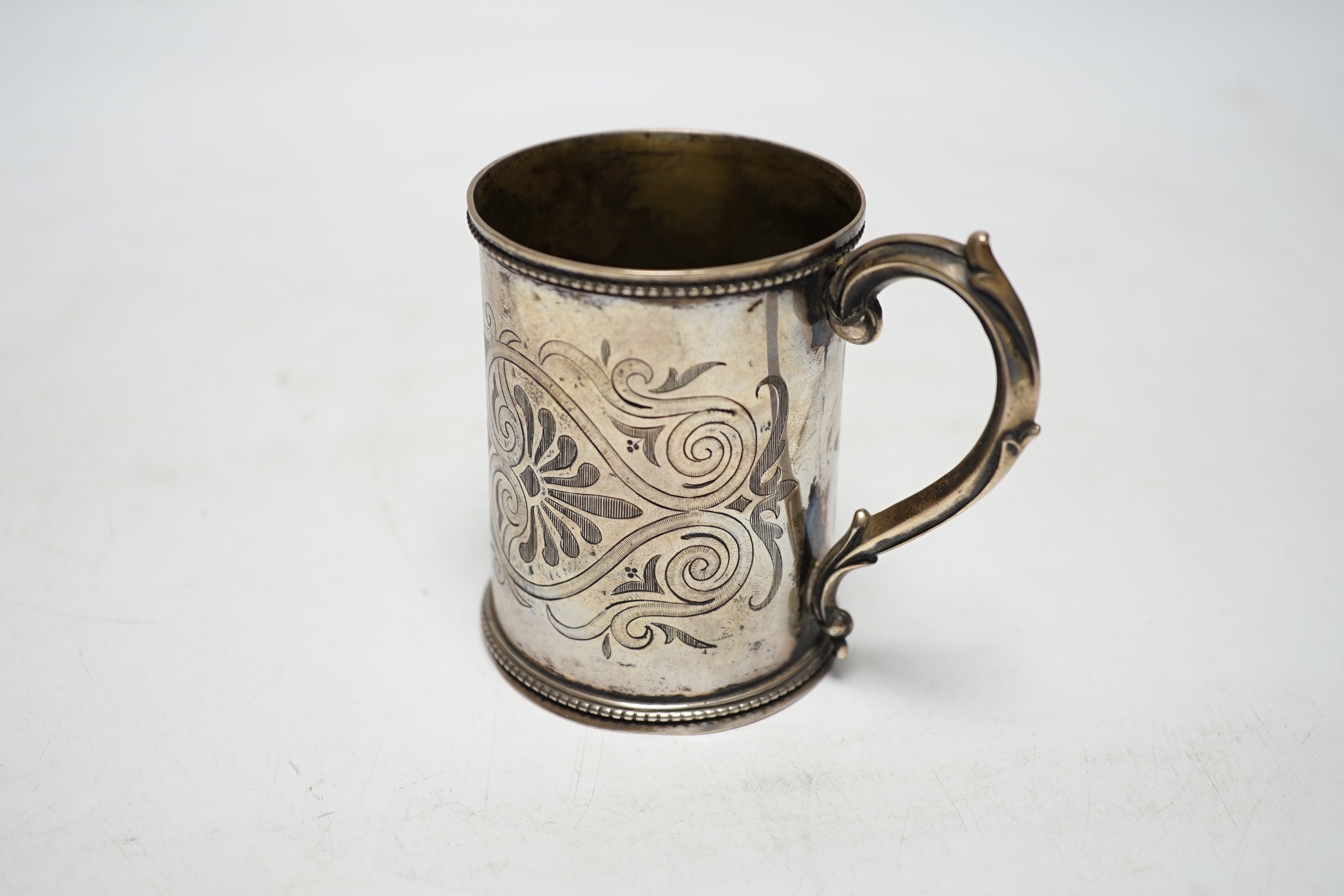 A Victorian engraved silver christening mug, Henry Holland, London, 1866, 87mm, 117 grams.